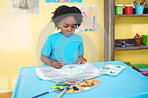 Happy kid painting on a sheet