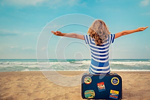 Happy kid playing outdoor against sea and sky