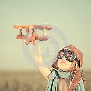 Happy kid playing with toy airplane