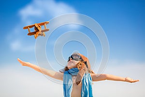 Happy kid playing with toy airplane