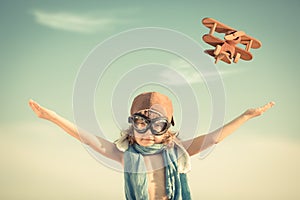 Happy kid playing with toy airplane