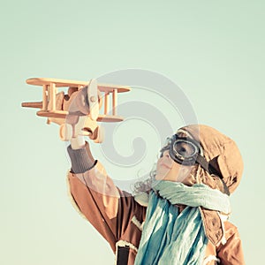 Happy kid playing with toy airplane