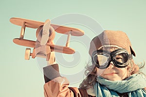 Happy kid playing with toy airplane