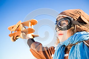 Happy kid playing with toy airplane photo