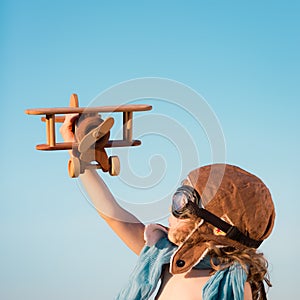 Happy kid playing with toy airplane