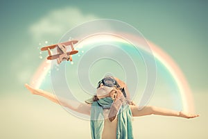 Happy kid playing with toy airplane