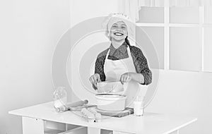 happy kid prepares dough in kitchen, bakery