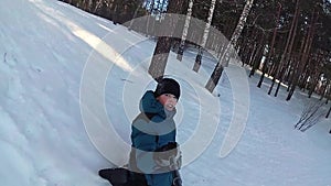 Happy kid rides and smiling snowtube on snowy roads.slow motion. snow winter landscape. outdoors sports