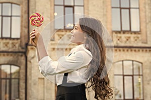 Happy kid with sweet candy. Happy childhood. Kid child holding lollipop candy outdoors. Happy kid with candy outdoors