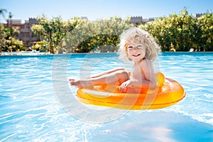 Happy kid swimming in pool