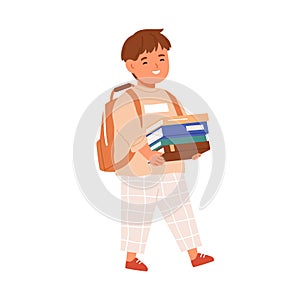 Happy kid walking with stack of books in hands and schoolbag. Elementary student child going with backpack to school. Schoolboy