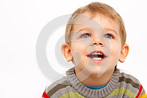 Happy kid in winter clothes looking up