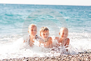 Happy kids on the beach having fun