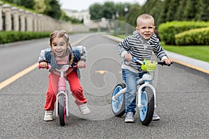 Happy kids with bikes having fun on the road at the day time