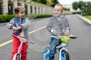 Happy kids with bikes having fun on the road at the day time