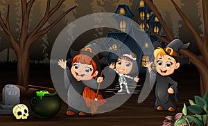 Happy kids celebration halloween day with haunted house background