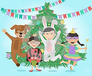 Happy kids in costumes having fun around the Christmas tree.