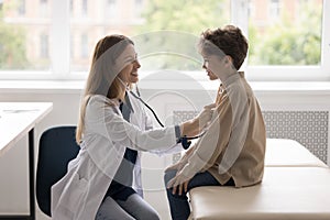 Happy kids doctor examining child for heart disease, flu