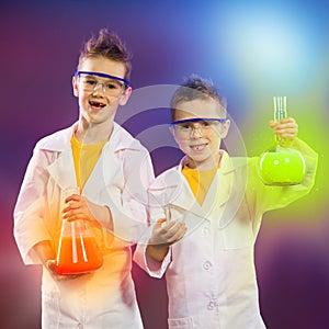 Happy kids doing science experiments in the laboratory.