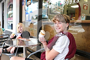 Happy Kids Eating Ice Cream Outside at Sweet Shop Restaurant