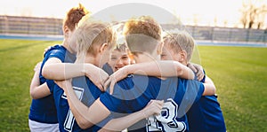 Happy kids in elementary school sports team celebrating soccer success in tournament final game