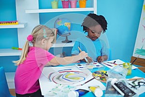 Happy kids enjoying arts and crafts painting