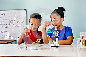 Happy kids with flasks in school chemistry laboratory