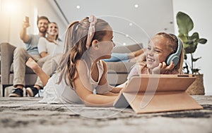 Happy kids on floor of living room with tablet, headphones and watching video, movie streaming or music. Digital game