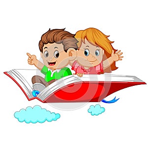 Happy kids flying on big open book