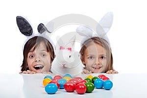 Happy kids found the easter bunny and the eggs dying site - isolated on white