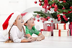 Happy kids in front of christmas tree