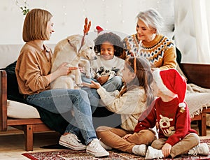 Happy kids getting dog for Christmas, multiethnic family with golden retriever celebrate New Year