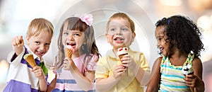 Happy kids group eating ice cream at a party in cafe