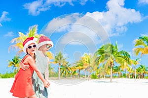 Happy kids have fun in Santa hat during Christmas beach vacation. New Year on the beach