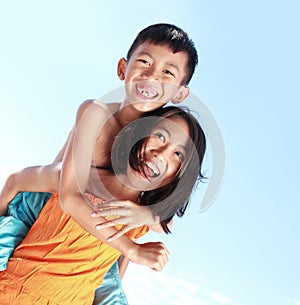 Happy kids having fun doing piggyback ride