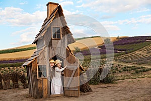 Happy kids having fun hiding in a fantasy wooden playhouse