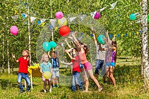 Happy kids having fun playing balloons outside