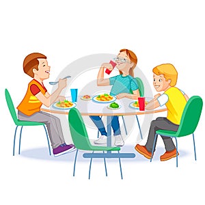 Happy kids having lunch by themselves. Two boys and girl eating lunch meals at table. Child nutrition concept.