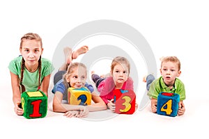 Happy kids holding blocks with numbers over white background