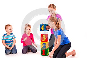 Happy kids holding blocks with numbers over white background