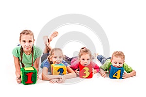 Happy kids holding blocks with numbers over white background