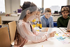 Happy kids with invention kit at robotics school