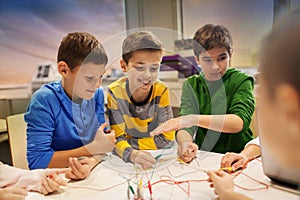 Happy kids with invention kit at robotics school