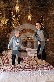 Happy kids jumping on bed