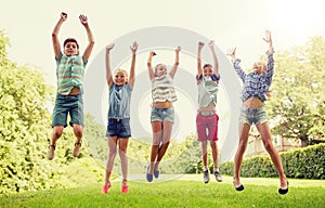 Happy kids jumping and having fun in summer park