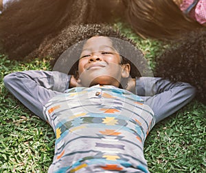 Happy kids laying on grass in park