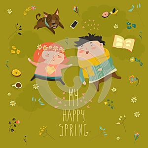 Happy kids lying on the meadow grass full of spring flowers