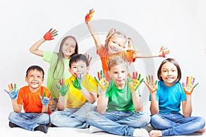 Happy kids with painted hands smiling