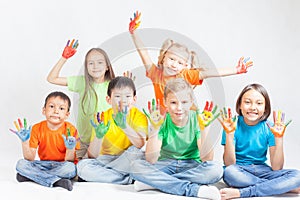 Happy kids with painted hands smiling