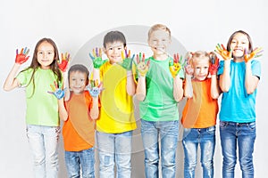 Happy kids with painted hands smiling